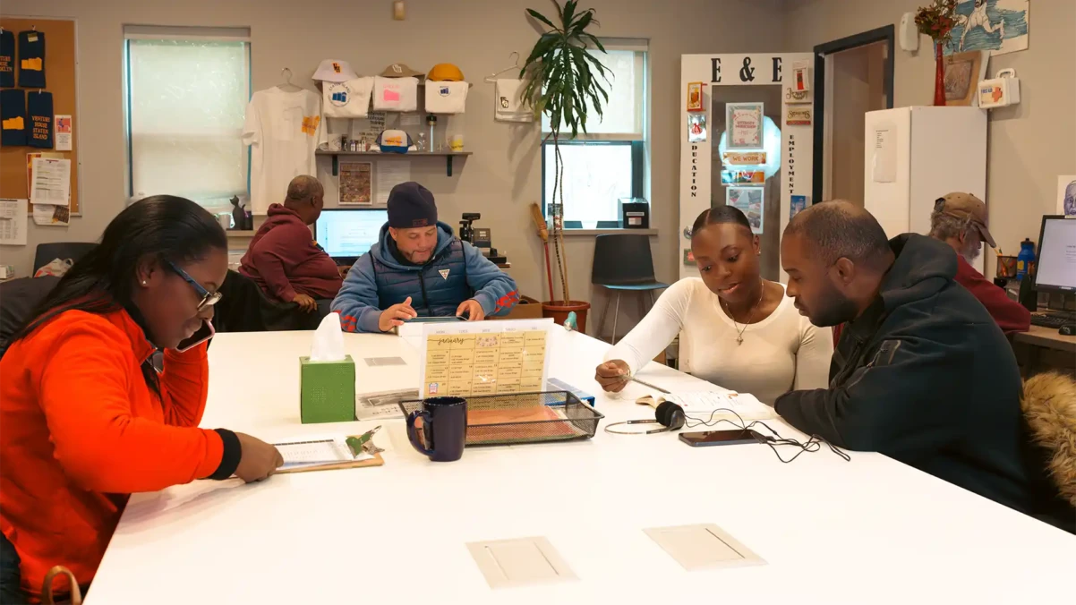 Venture House members sitting at a table together working