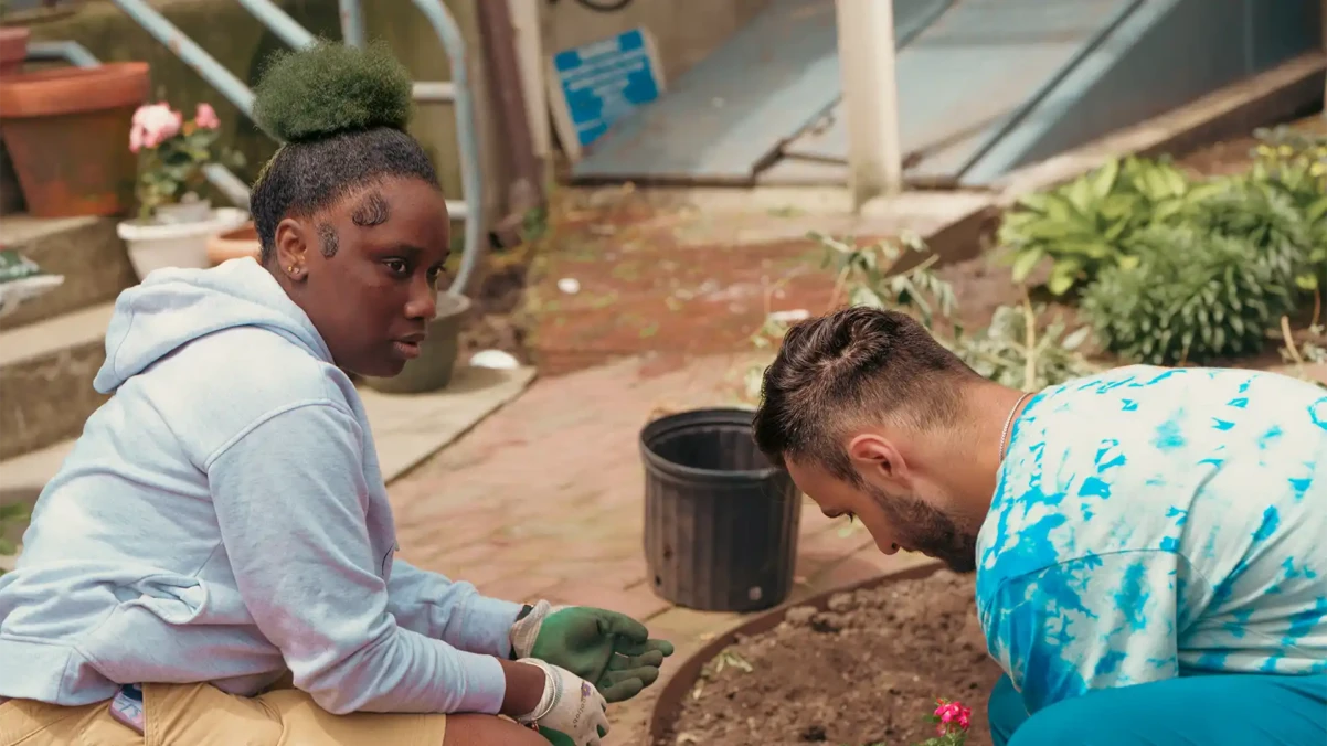 Venture House members gardening outside together
