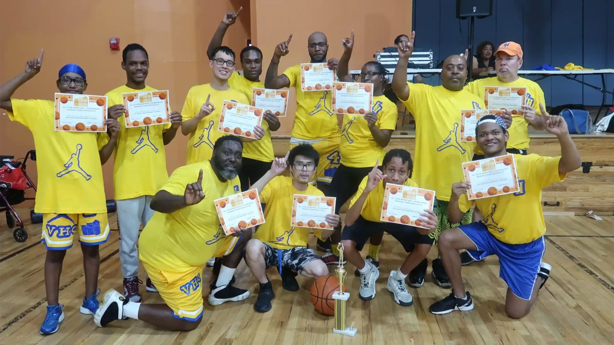 Venture House basketball team members posing with their trophy